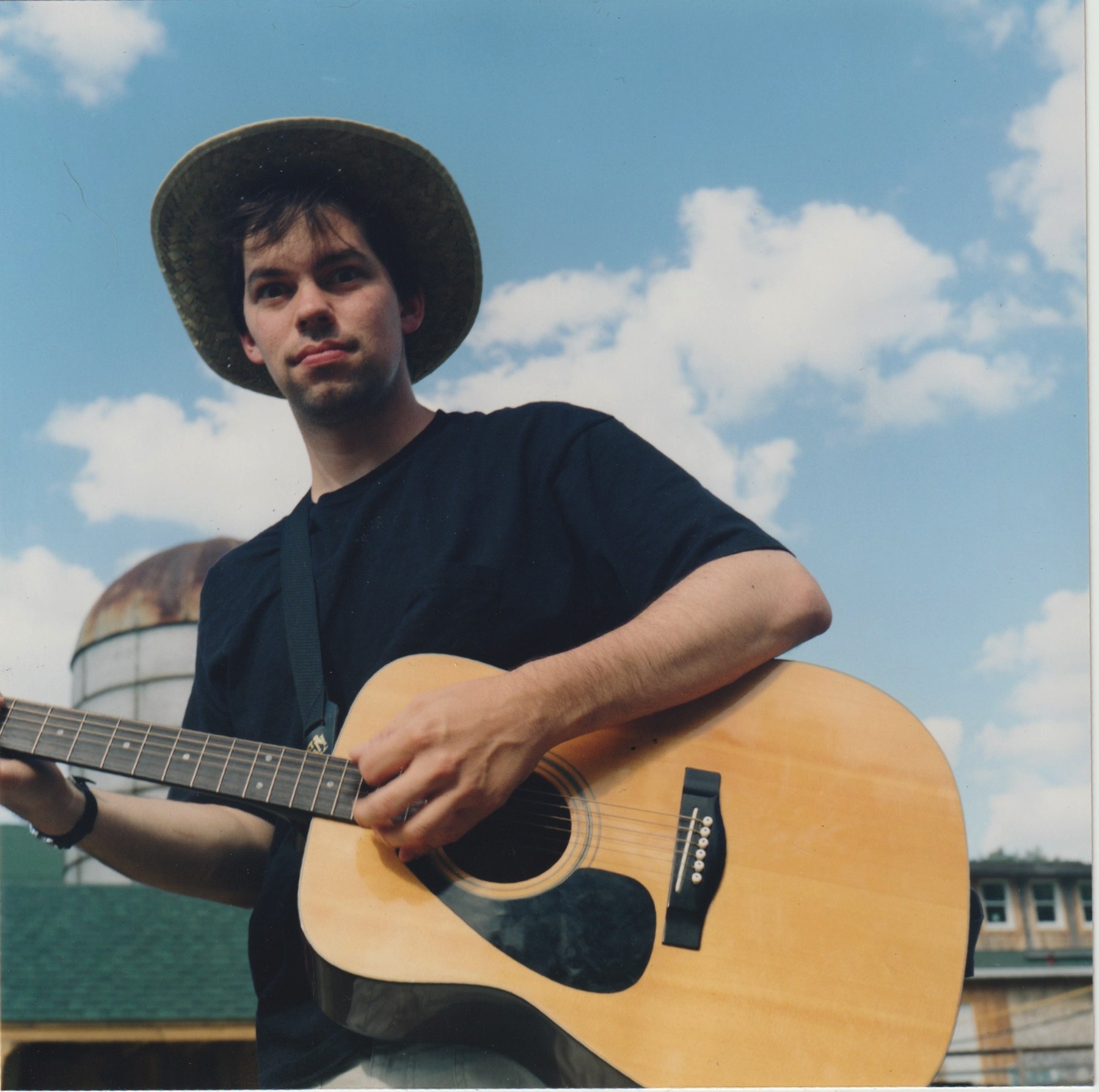 David Rhoden holding his guitar in Deposit, New York, July 1998.