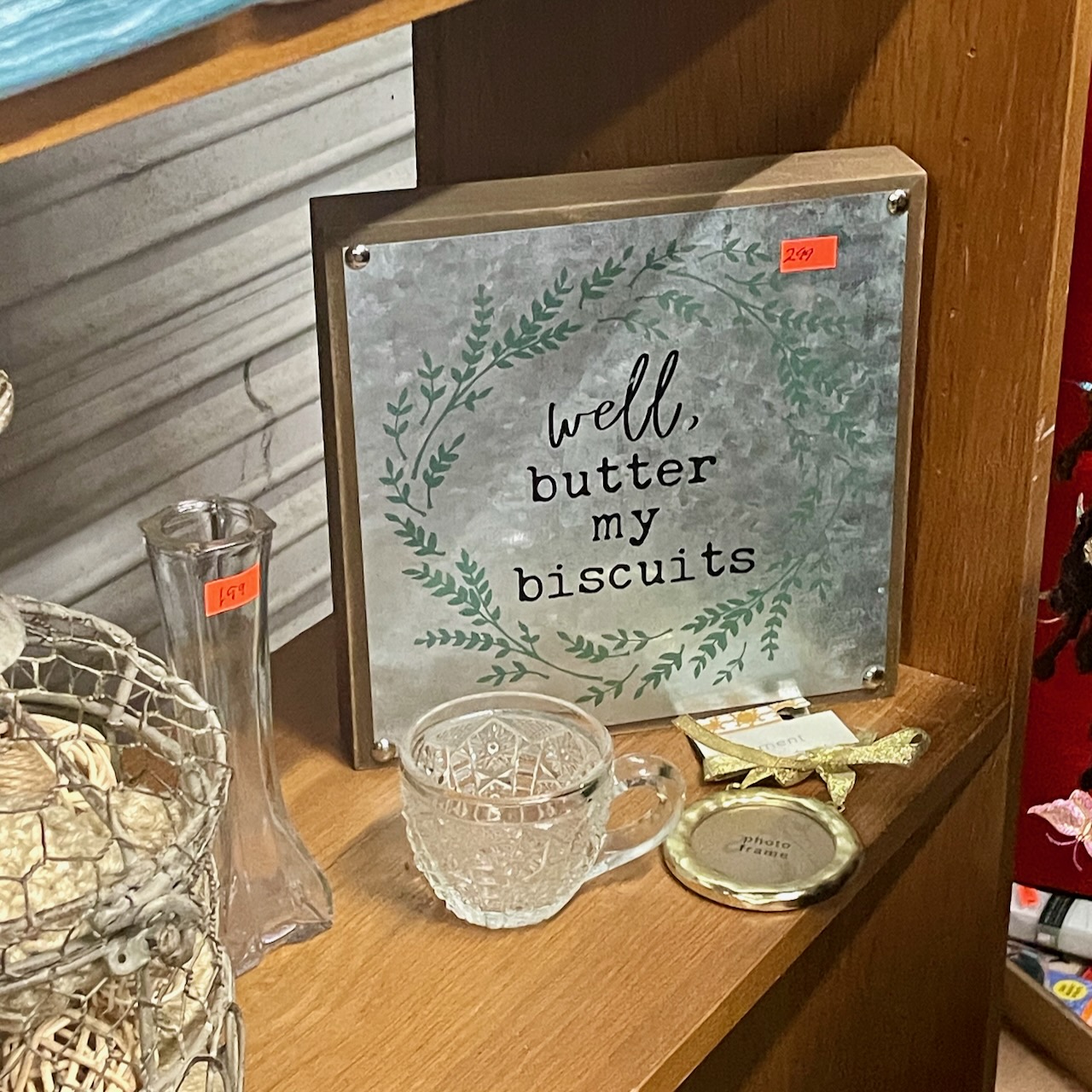 thrift-store plaque that says "well, butter my biscuits". ("Butter my biscuits" is a lyric from the Jimmy and The Wolfpack hit "Barnyard Boogie".)