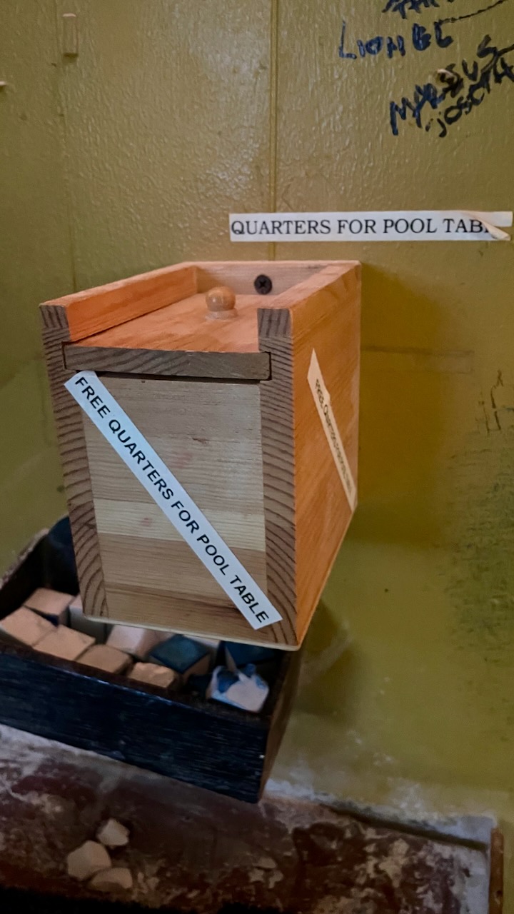 A box of free quarters by the pool table at Boomerangs