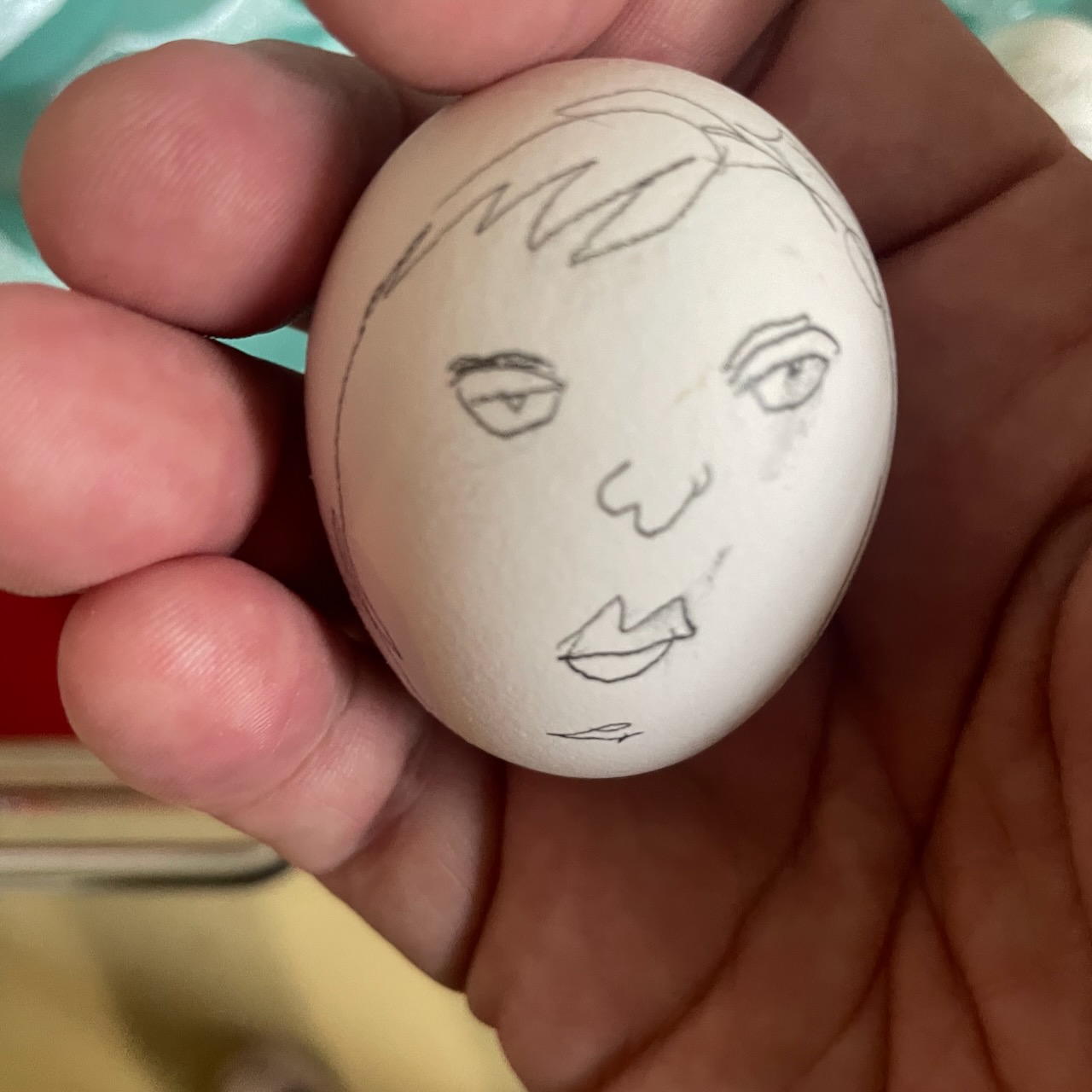 egg with a sullen little face drawn on it by David Rhoden