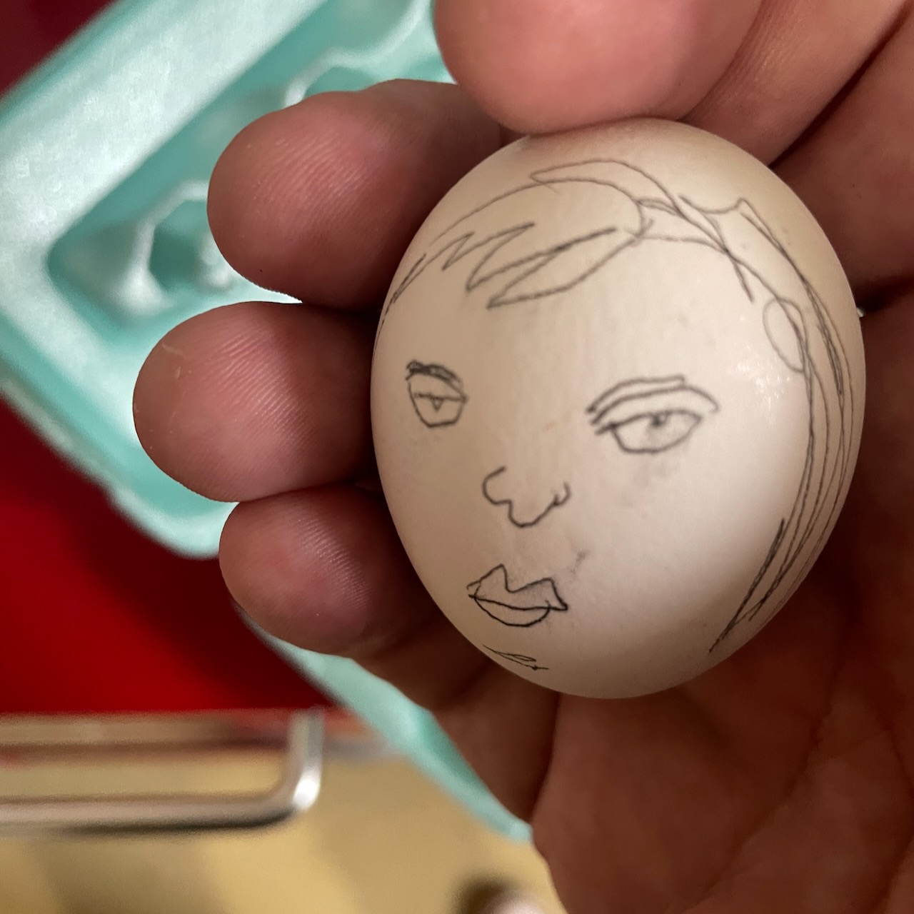 egg with a sullen little face drawn on it by David Rhoden