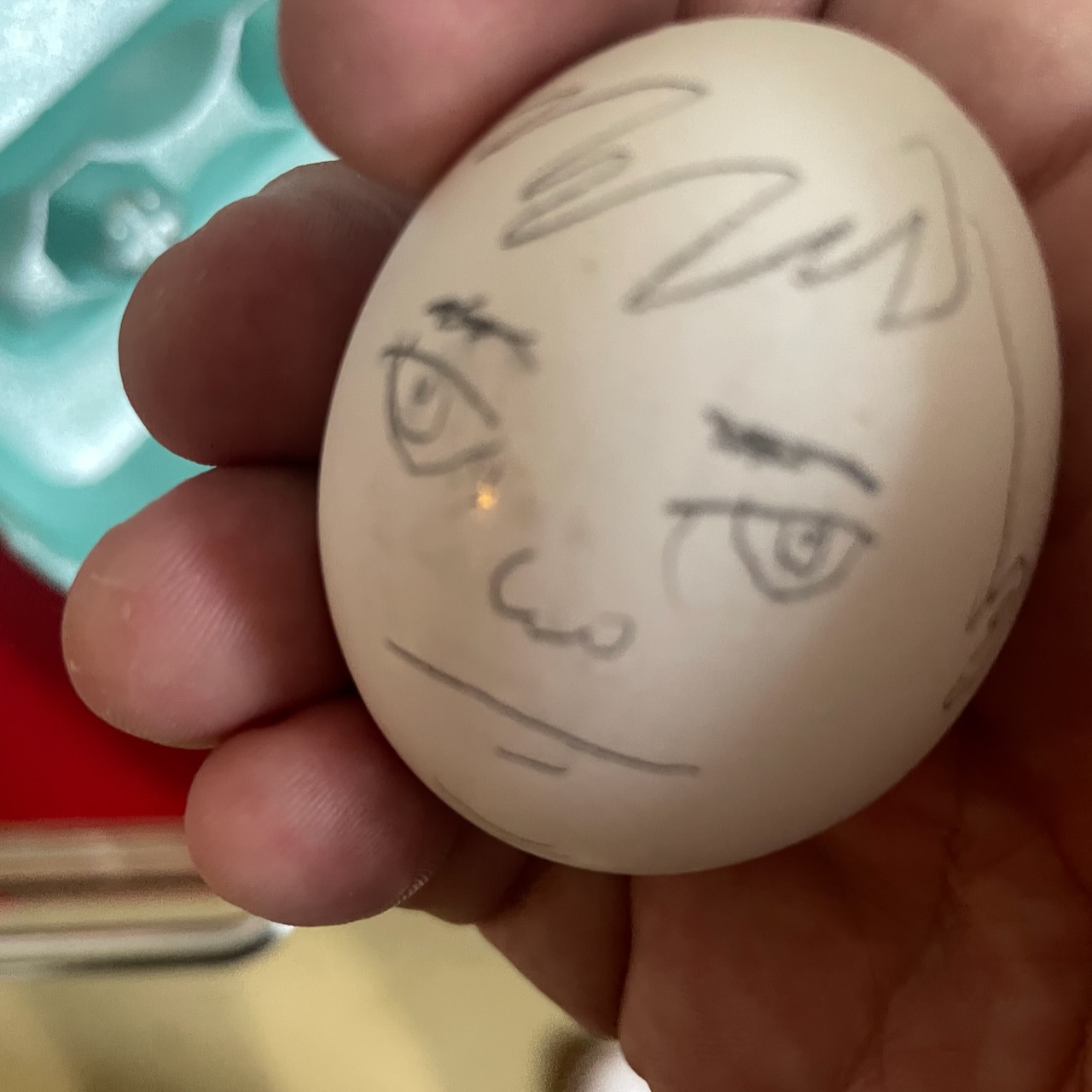 egg with a sullen little face drawn on it by David Rhoden