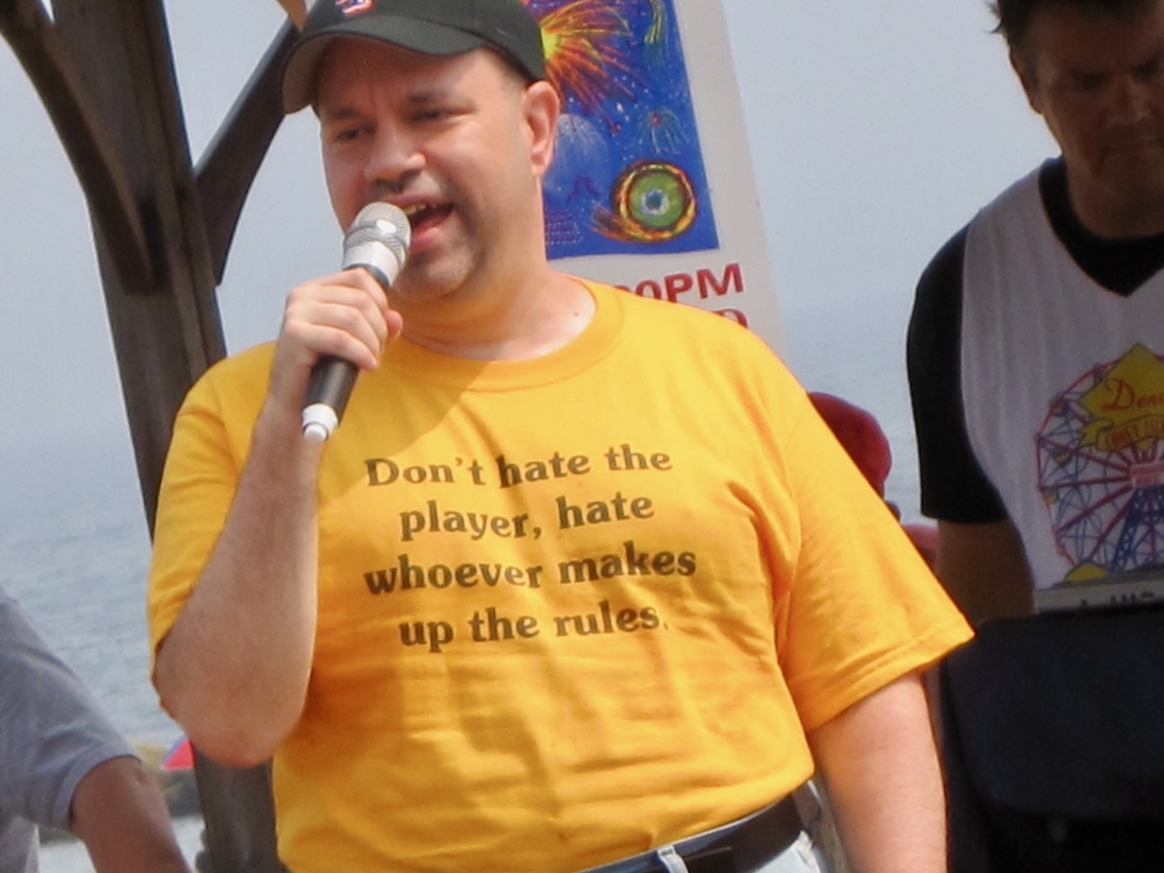 The Unknown Karaoke Singer, Coney Island Boardwalk, June 10, 2010. his t-shirt says "Don't hate the player, hate whoever makes up the rules."