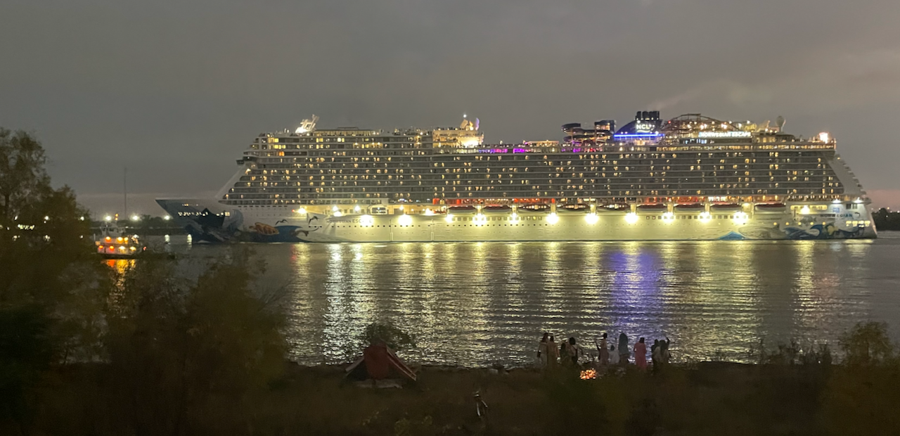bonfire and cruise ship seen from Mississippi River levee