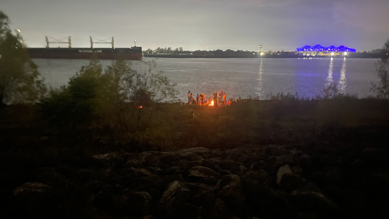 bonfire and people seen from Mississippi River levee