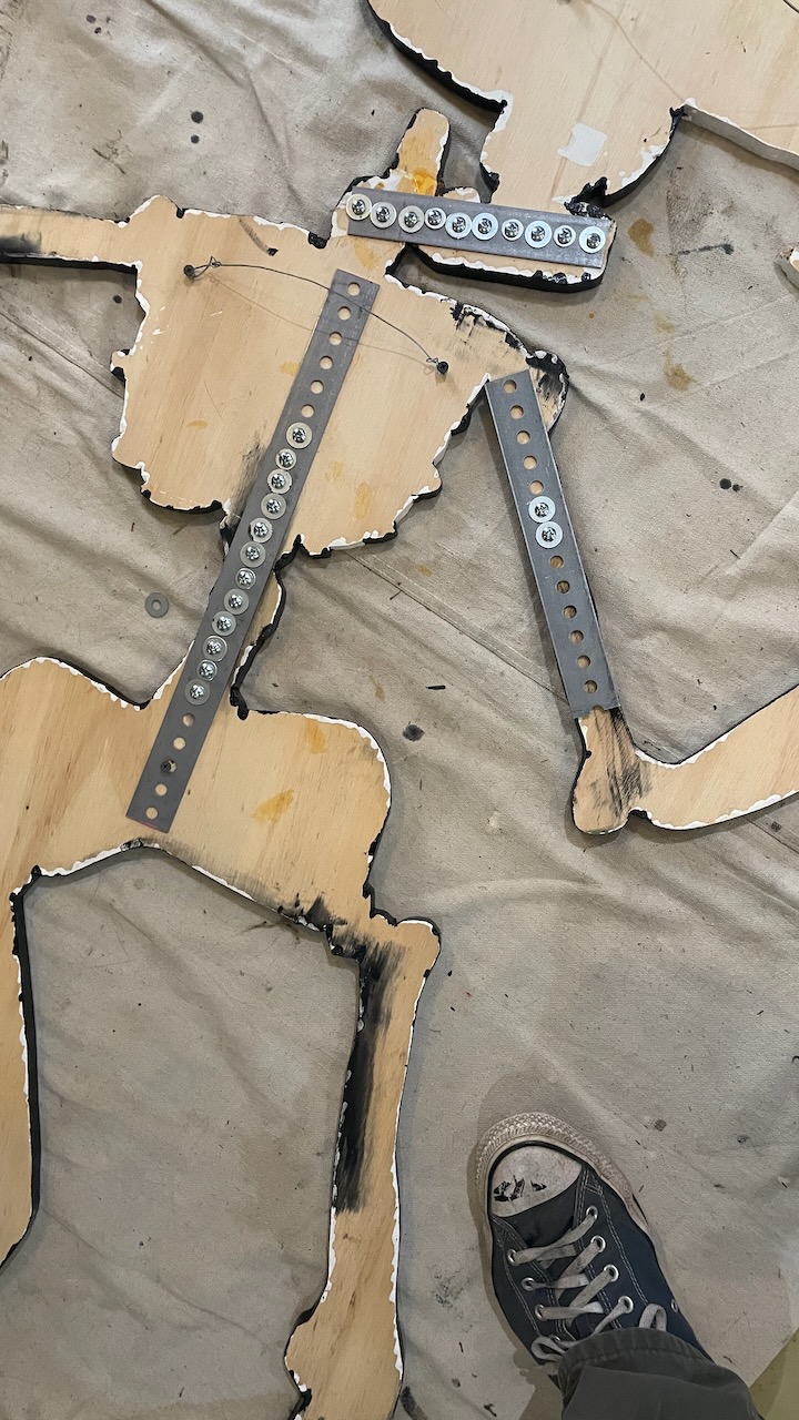 skeleton artwork repairs seen from back --lots of screws