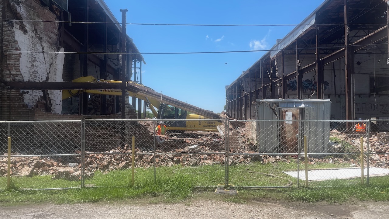 The old warehouse across Tricou Street started coming down.